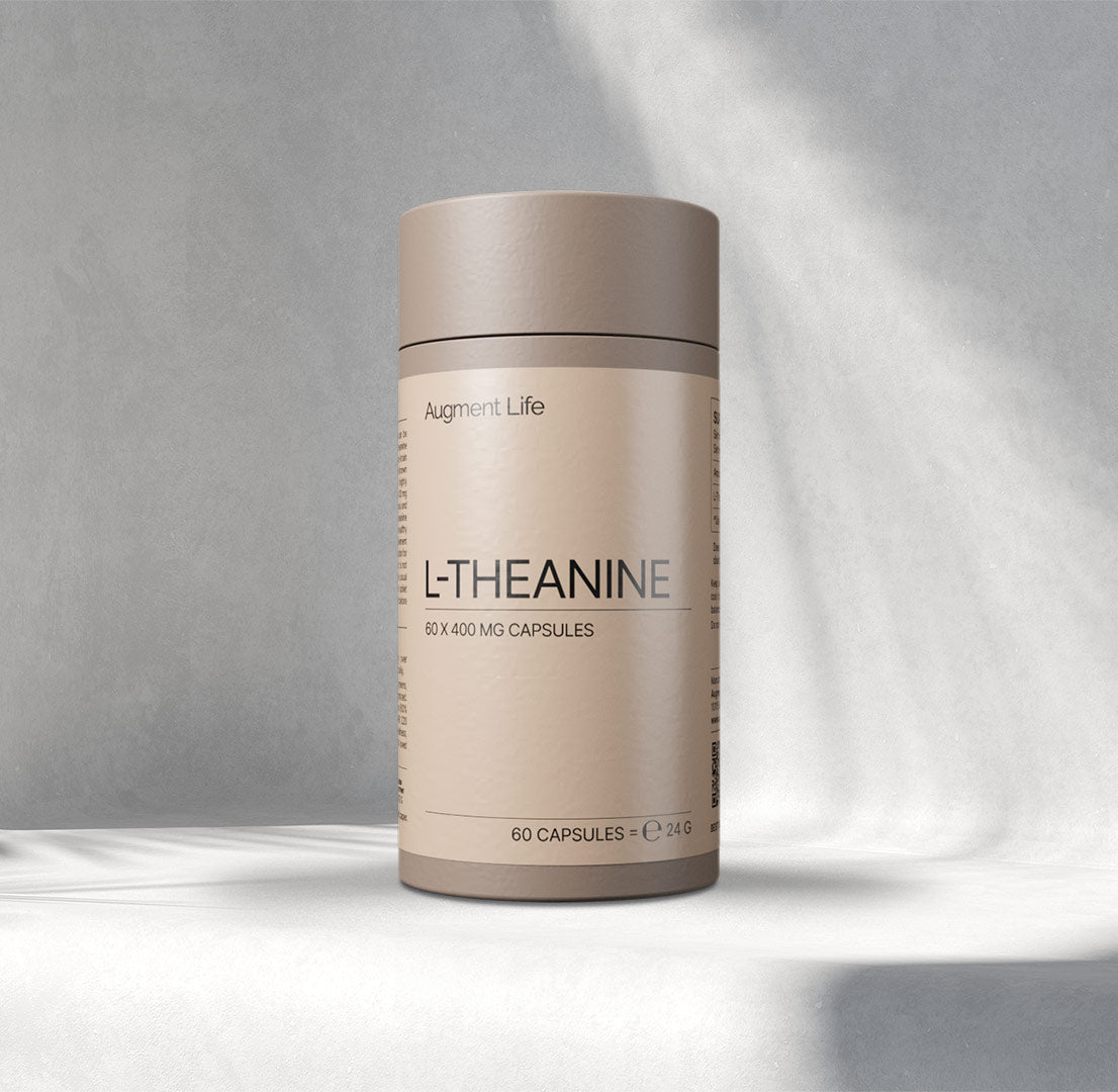 A beige cylindrical container labelled "L-Thea nine, 60 x 400 mg capsules" by Augment Life sits on a softly lit Gray background, exuding a calm, minimalist vibe.