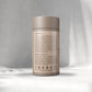 A beige cylindrical container labelled "L-Thea nine, 60 x 400 mg capsules" by Augment Life sits on a softly lit Gray background, exuding a calm, minimalist vibe.