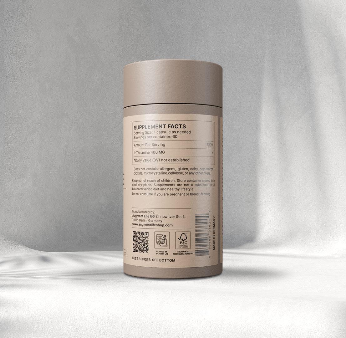 A beige cylindrical container labelled "L-Thea nine, 60 x 400 mg capsules" by Augment Life sits on a softly lit Gray background, exuding a calm, minimalist vibe.